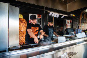 Photos of employees using cooktop at El Parian for Southwest Restaurant Week feature