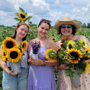 women holding hand-picked flower bouquets at Debucks Family Farm in Belleville, Michigan.