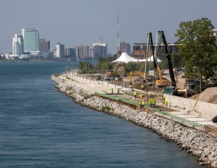 Workers begin pouring cement at the Detroit RiverWalk in-between Mt. Elliott Park and the MacArthur Bridge in Detroit