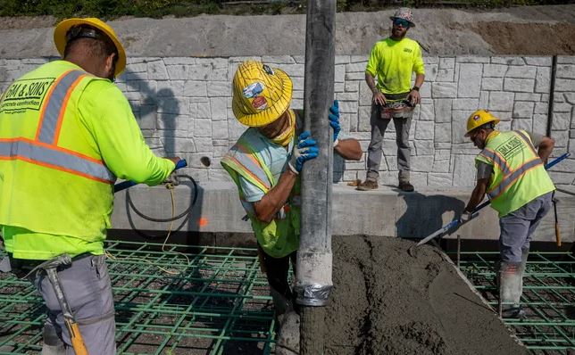 Rafael Orozco pour concrete between Mount Elliott Park and the MacArthur Bridge in Detroit