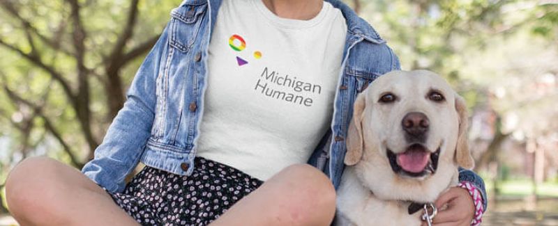 Michigan Humane Society volunteer posing with dog